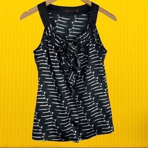 The Limited Sleeveless Black Top with White Patten Design and Ruffle Accents